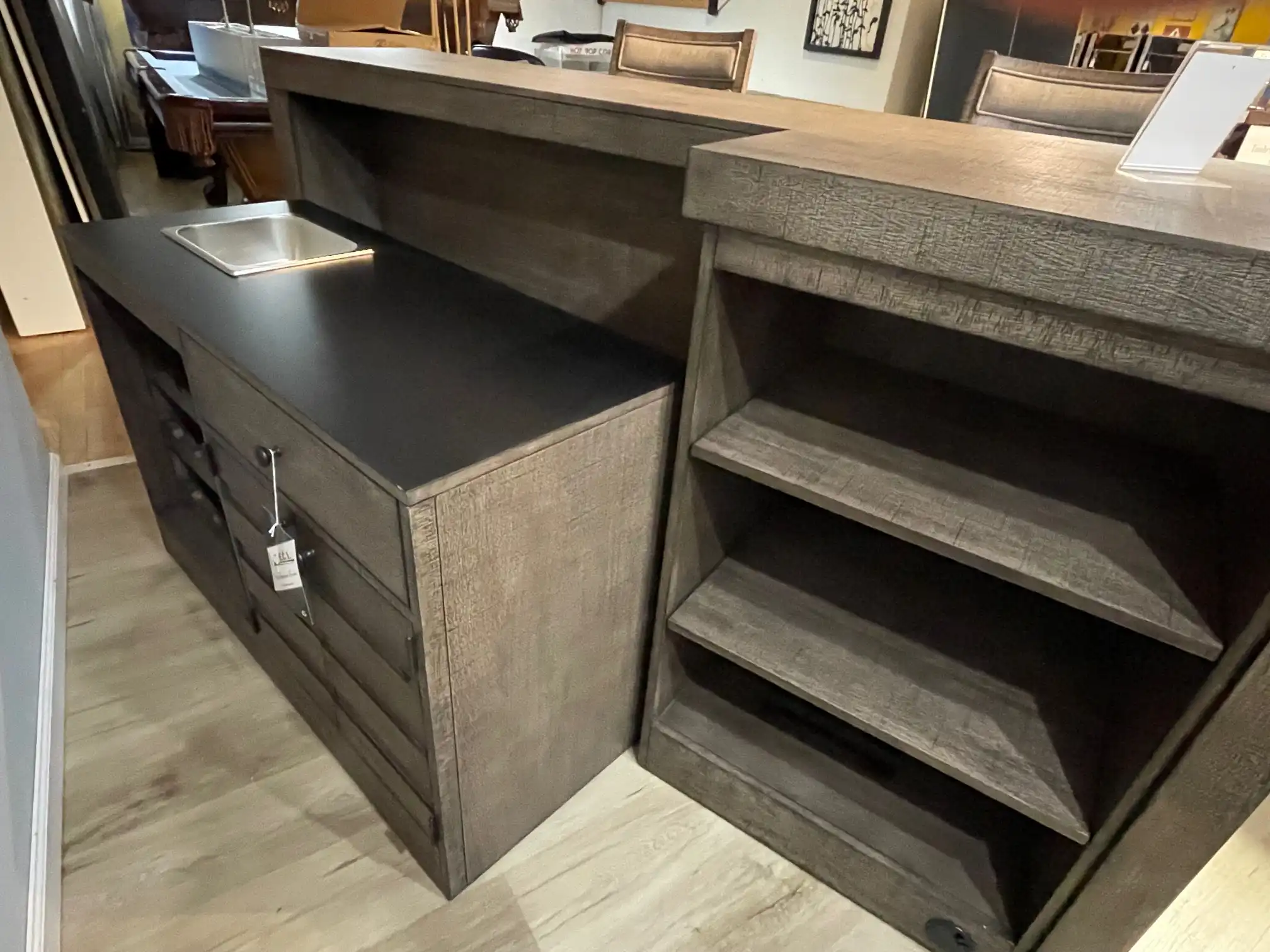 ECI Furniture Spring Haven 4-piece gameroom bar set. View of the working side featuring a dark countertop, built-in sink basin, and a moveable shelf cart.