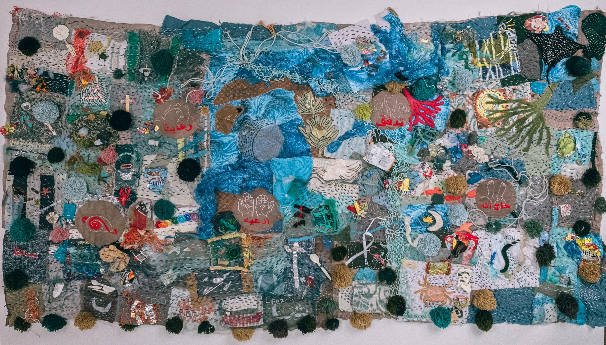 Mother Hydro-Rug in its current form, 2021-ongoing, 267cm x 140cm. Layers of discarded cotton cloth dyed with Protea Nitida, with found plastic objects from beach clean-ups spanning multiple years stitched together with thread