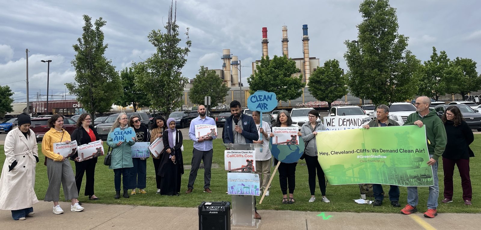 Community members holding Clean Air signs at a rally in Michigan
