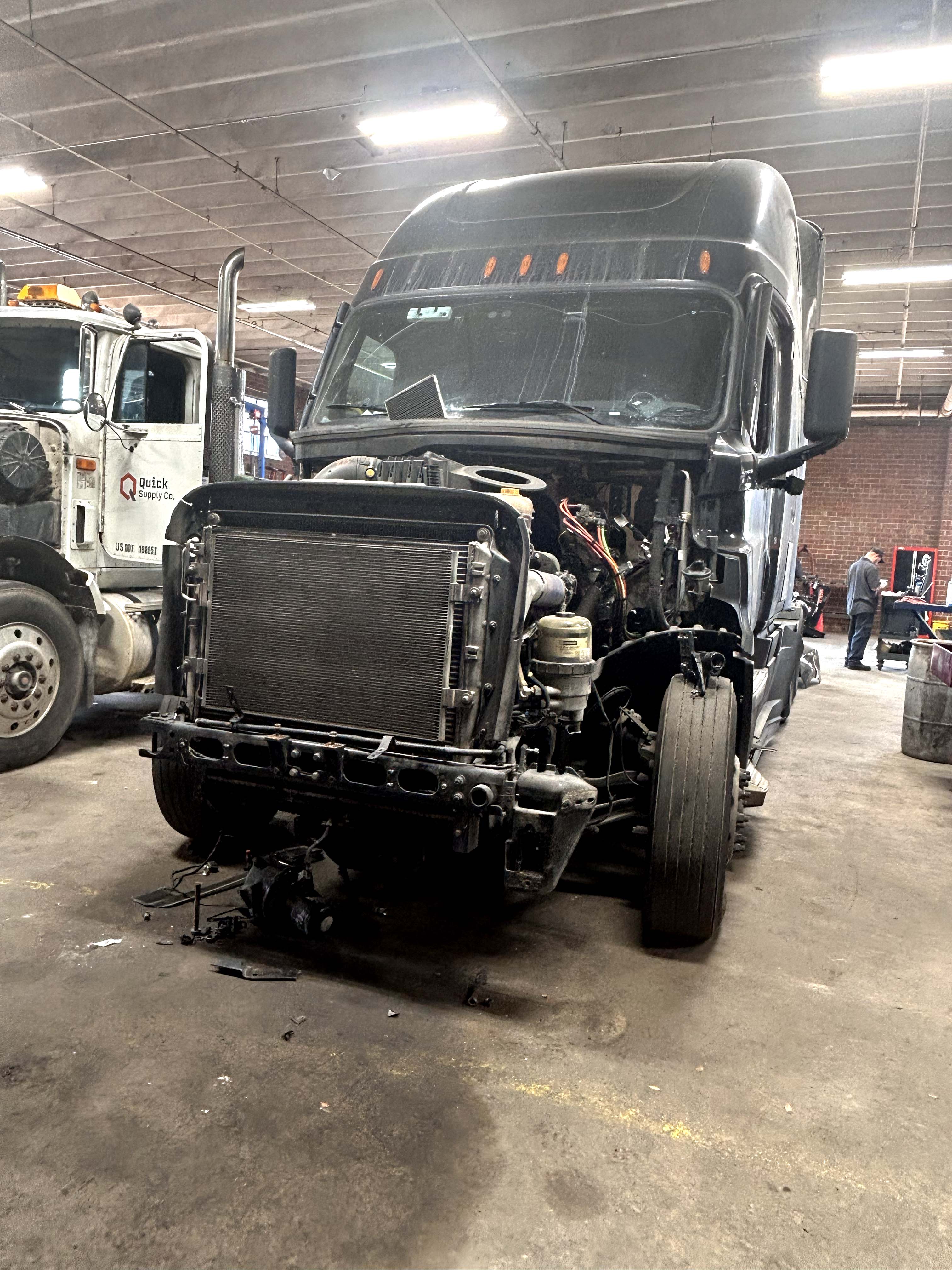 Diesel mechanic performing coolant system repairs on semi truck in Statesville, NC