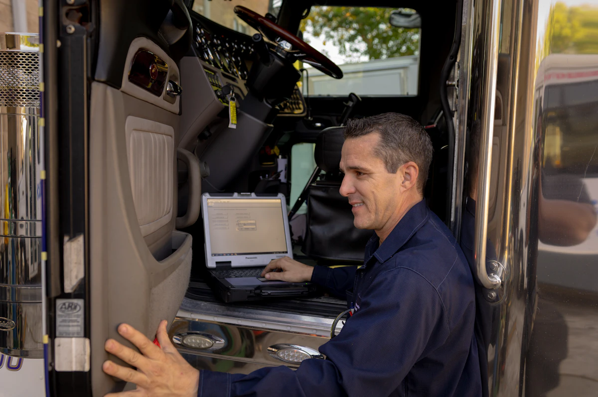 mechanic with laptop for diagnostics