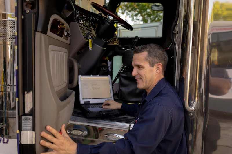 mechanic with laptop for diagnostics