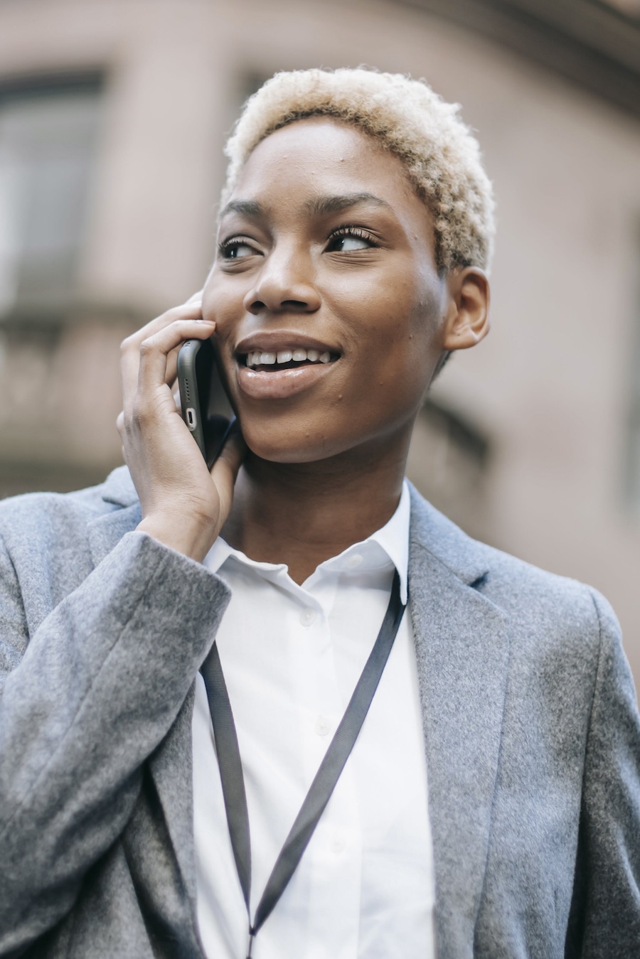 low angle of black business woman on mobile