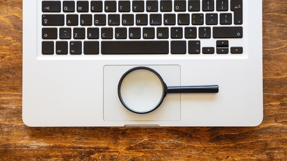 Magnifying glass on a keyboard for video success