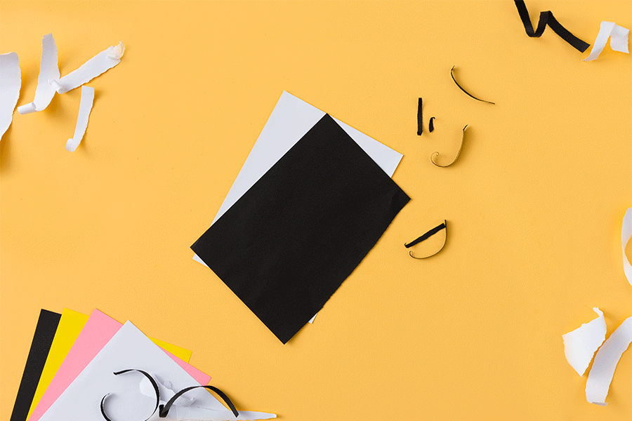 A series of images showing how to create a paper pelican (junggar) for NAIDOC Week. This example uses black, pink, yellow and white construction paper, scissors and glue.