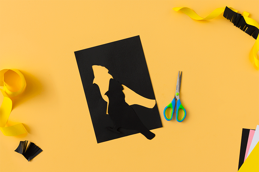 A series of images showing how to create a paper yellow-tailed black cockatoo (weelan) for NAIDOC Week. This example uses black, pink, yellow and white construction paper, scissors and glue.