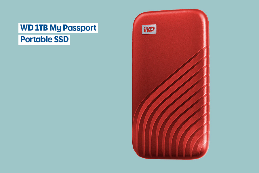 Red WD 1TB My Passport Portable SSD with wave-pattern design displayed against a teal background.