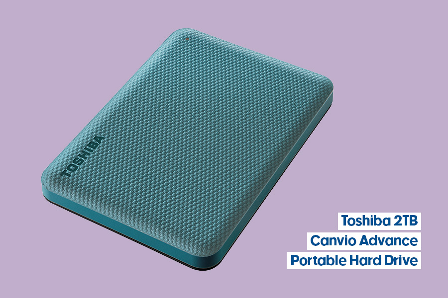 Toshiba 2TB Canvio Advance Portable Hard Drive with mint-green textured surface displayed against a purple background.