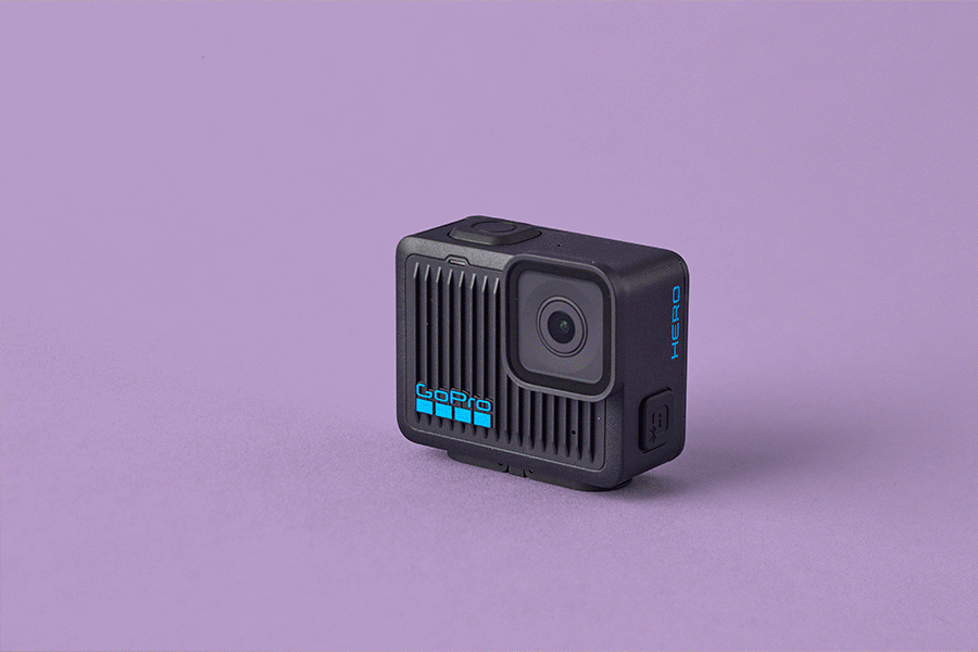 A series of tech gifts for Dad, shown on a purple background. Products include a black GoPro HERO camera and a dark green Garmin Vivoactive 5 smartwatch.