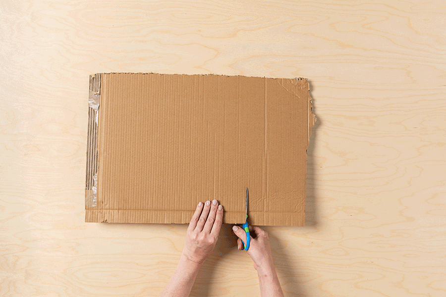 A series of images showing the process of cutting out and drawing on a piece of cardboard to create a faux picture frame.