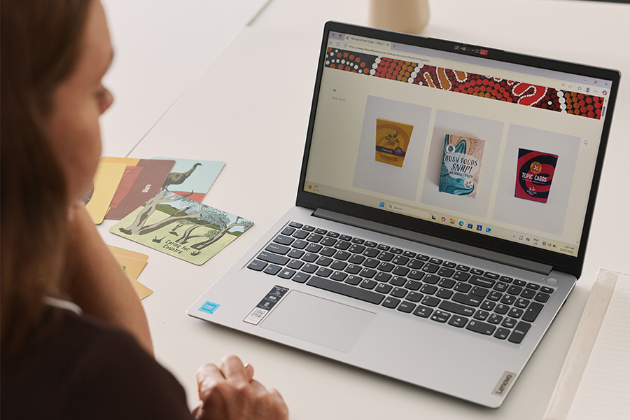 Debbie Hoger, owner of the small business Riley Callie Resources, sitting at a desk looking at her online shop.