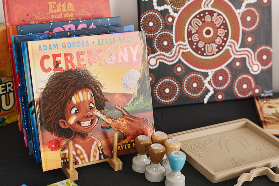 Riley Callie Resources, including books, small stamps and sensory trays, arranged together on a table.