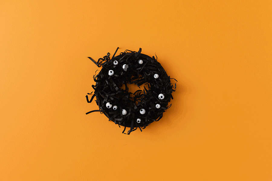 A series of images showing how to make an eyeball wreath for a Halloween craft project for kids.