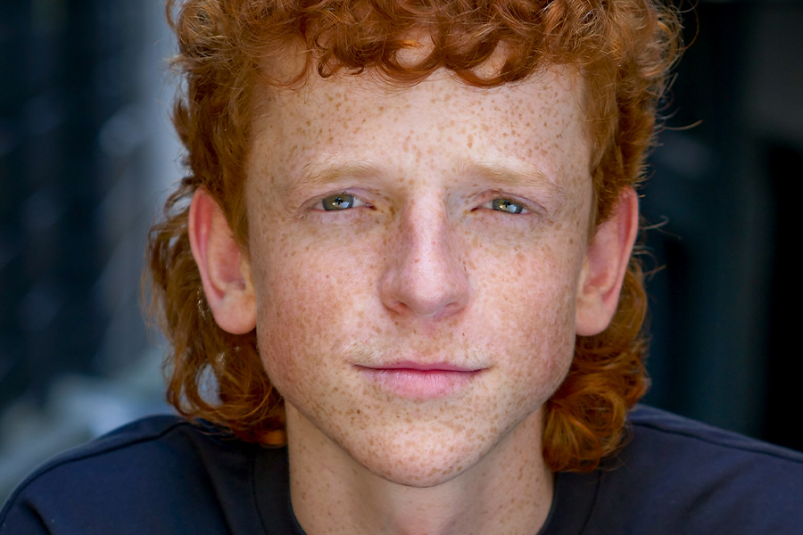 A close-up portrait of Jamie Rogers against a blurred background.