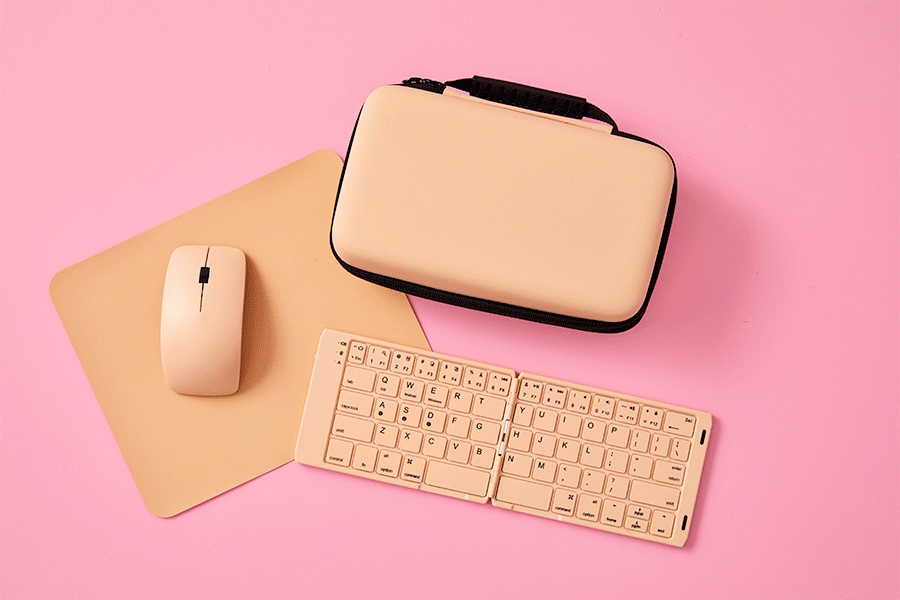 A selection of Christmas gifts for tech lovers, shown on various brightly coloured backgrounds. Products include a keyboard and mouse set and a gaming headset.
