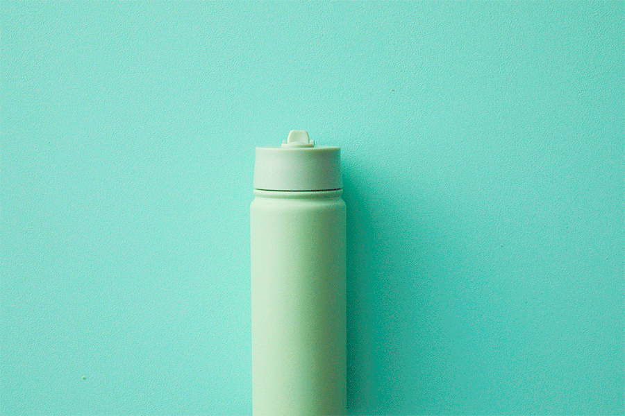 A GIF series of an assortment of personalised printed sticker labels and one being stuck on a light green water bottle.