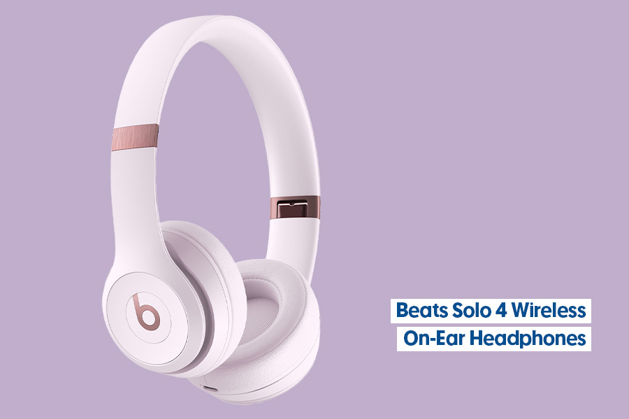 Beats Solo 4 wireless on-ear headphones in pink, shown against a purple background.