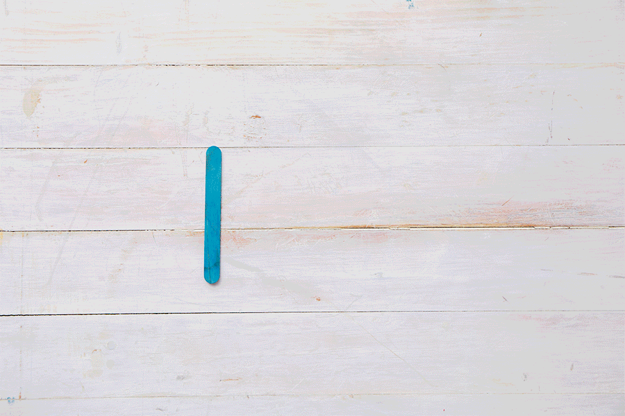 A series of images demonstrating Step 1 of making a popsicle stick bridge, showing eight sticks being glued together with two sticks across the top and bottom. Then repeated twice to create three panels.