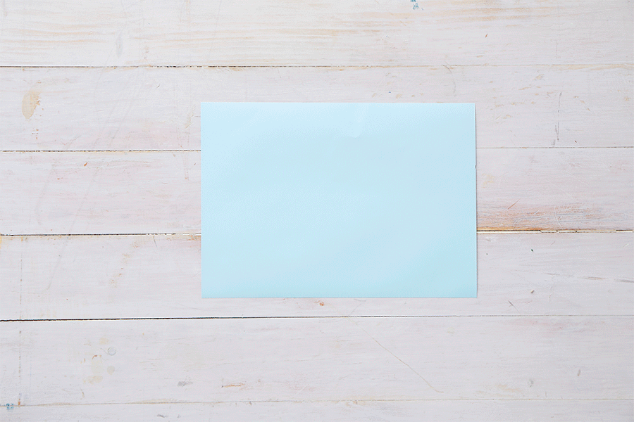 A series of images demonstrating Step 2 of making recycled box builders, showing hands wrapping a small box tightly with light blue paper.