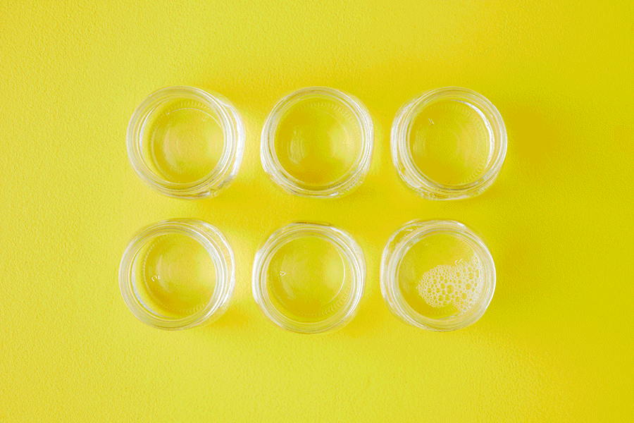 A series of images showing eggs in glass jars containing vinegar and different-coloured food dye to make rainbow coloured eggs as a STEM activity for kids.