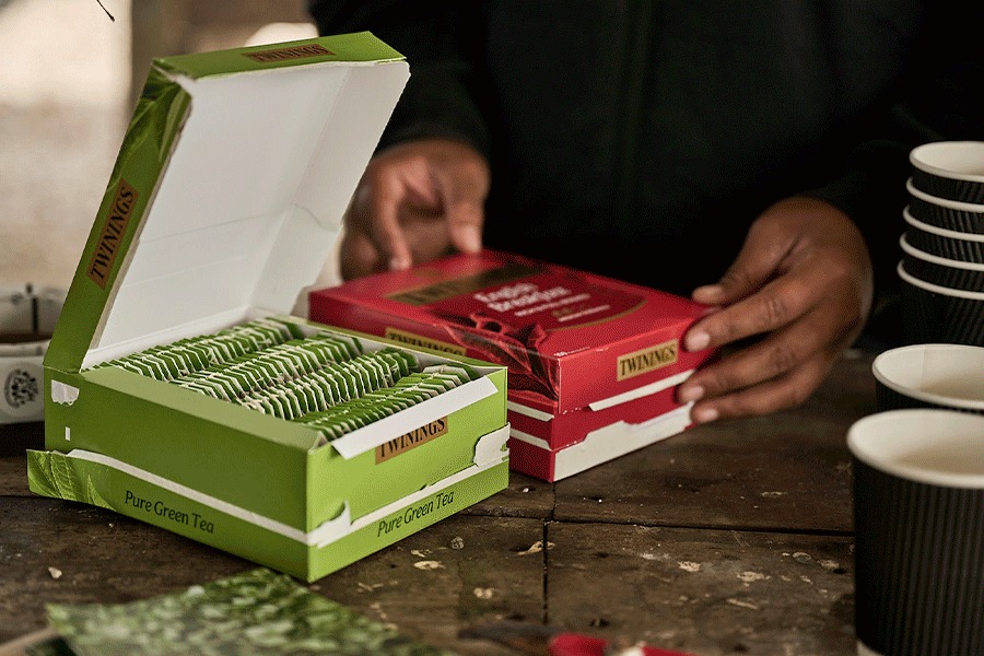 A series of images showing an assortment of catering supplies. Products include boxes of tea, tins of instant coffee, bottled water, paper plates and wooden cutlery.