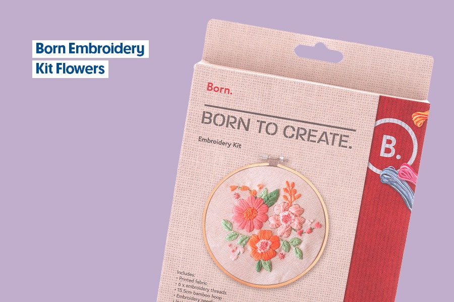 Born Embroidery Kit Flowers, featuring a floral embroidery hoop design, shown against a purple background.