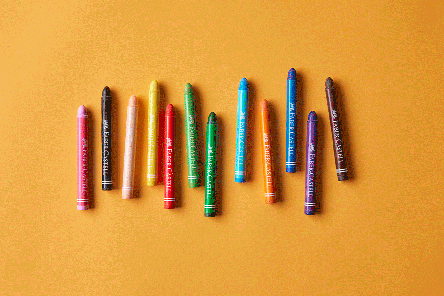 A series of images showing school holiday busy box items, including a small whiteboard with magnets and markers, notebooks and crayons, and sensory toys, against an orange surface.