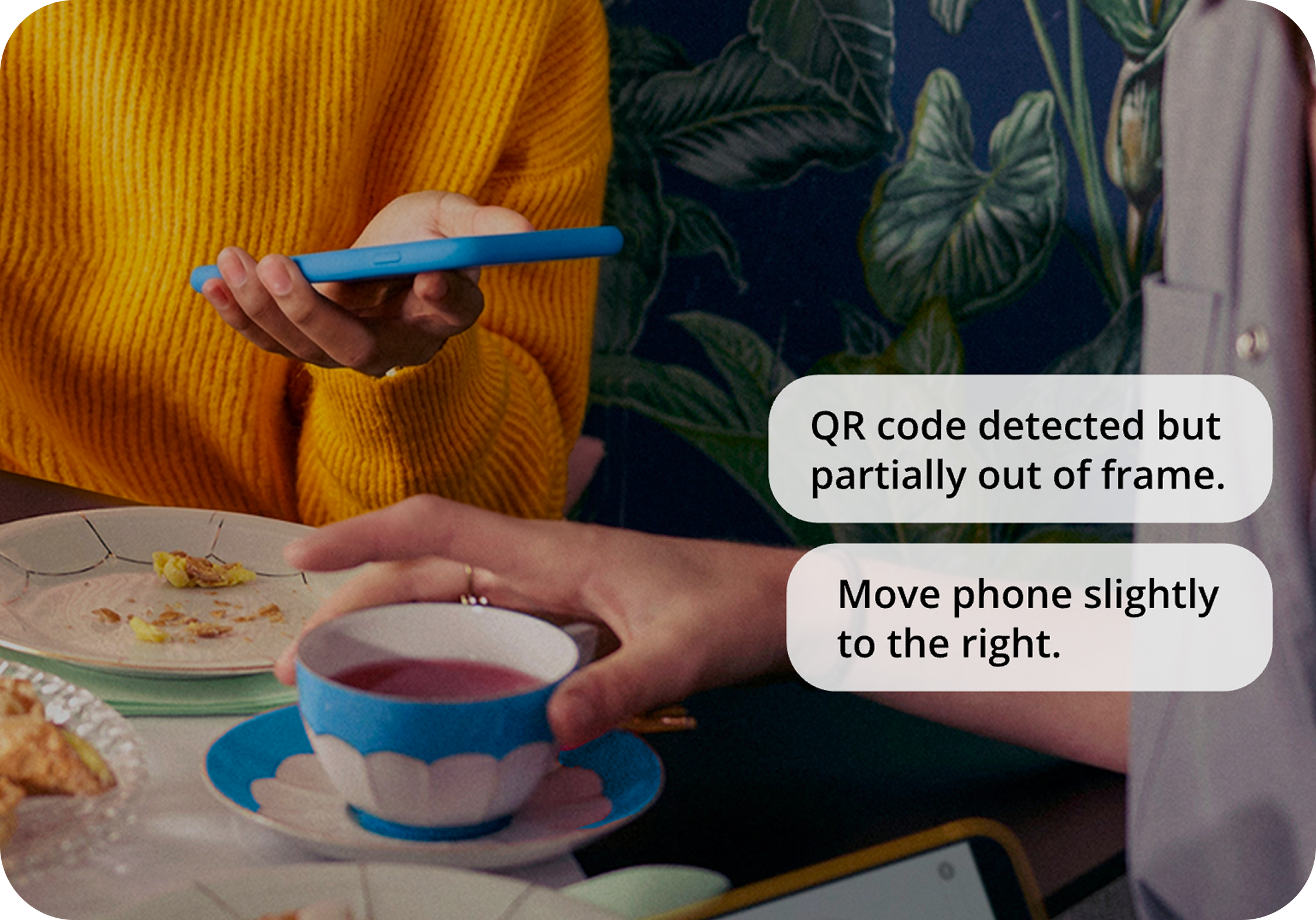 A photo showing someone scanning a QR code. The caption of the notification reads: "QR code detected but partially out of frame. Move phone slightly to the right.'