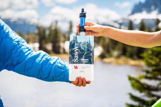 Two people holding a Sawyer mini water filter