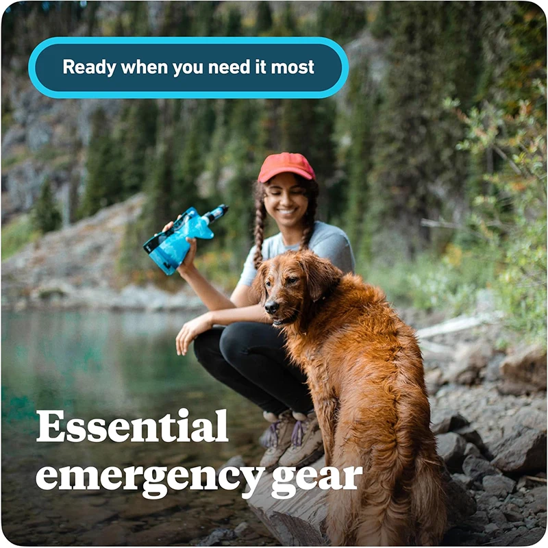 Woman sitting on rock with dog next to lake holding Sawyer mini water filter and pouch with text reading "Ready when you need it most" and "Essential emergency gear"
