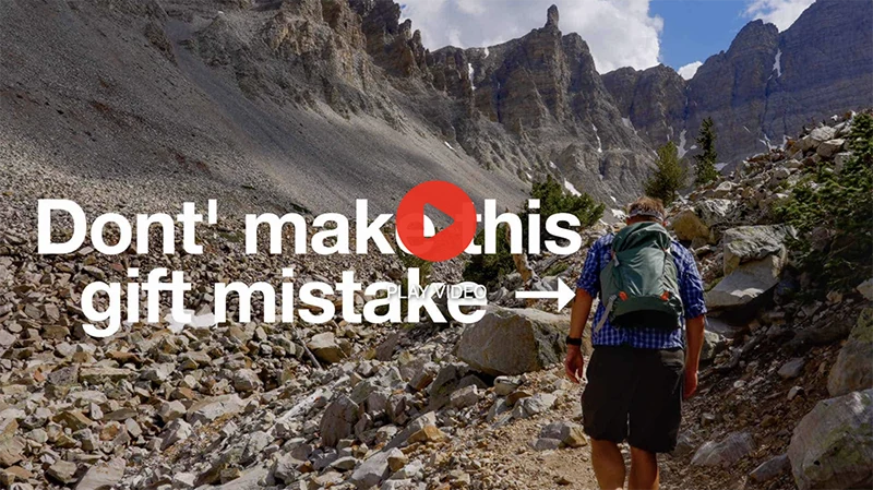 A man hiking on a mountain trail.
