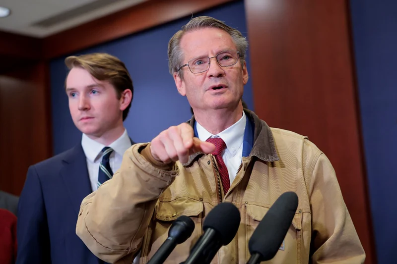 Two men in front of microphones