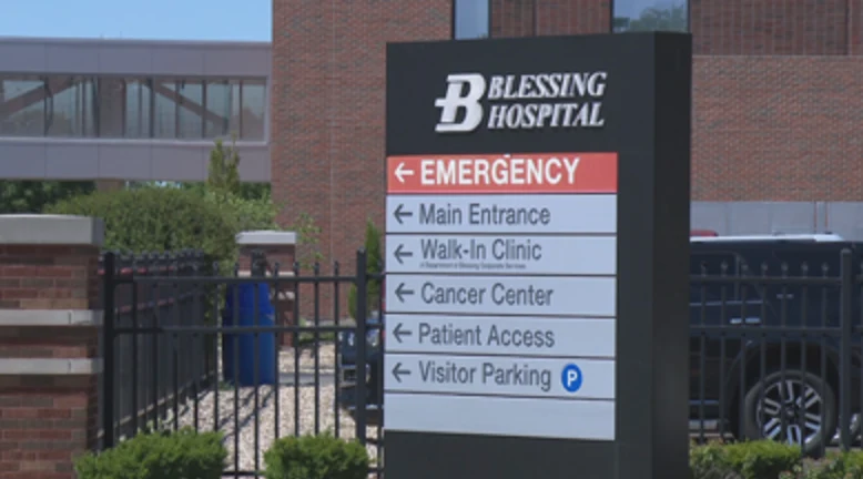 A hospital sign with directions to departments. 