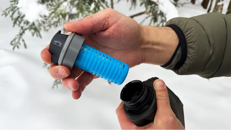 Hands holding a water filter.