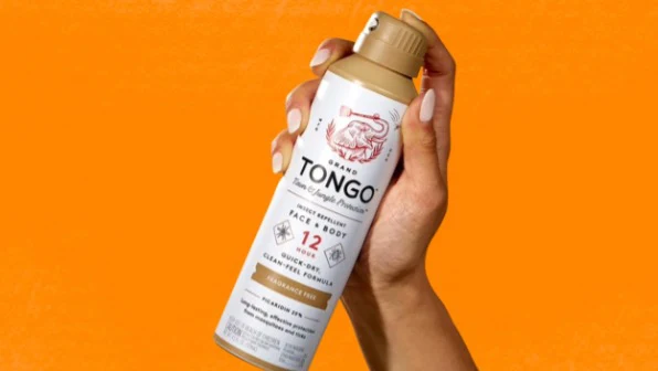 A hand holding Grand Tongo's Deet Free Insect Repellent