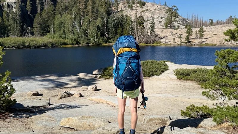 A hiker looking at a lake.