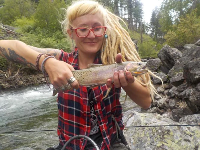 A woman holding a fish.