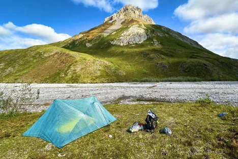 A camp site in front of a mountain.