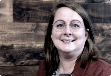 woman in a sweater smiling in cafe