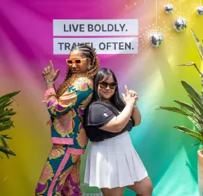 two ladies standing close and smiling