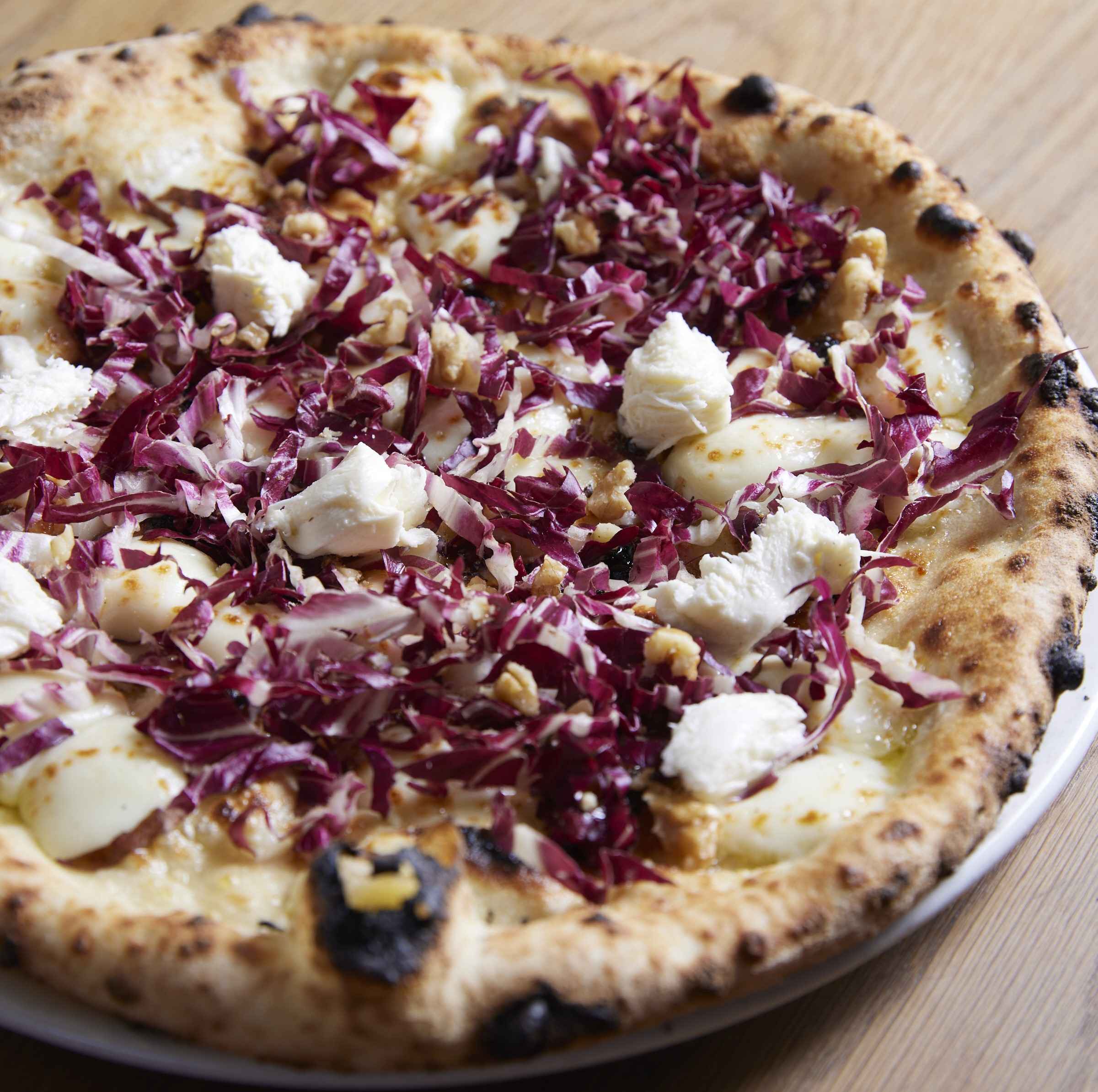 A woodfired pizza topped with radicchio and cheese at Piccolino