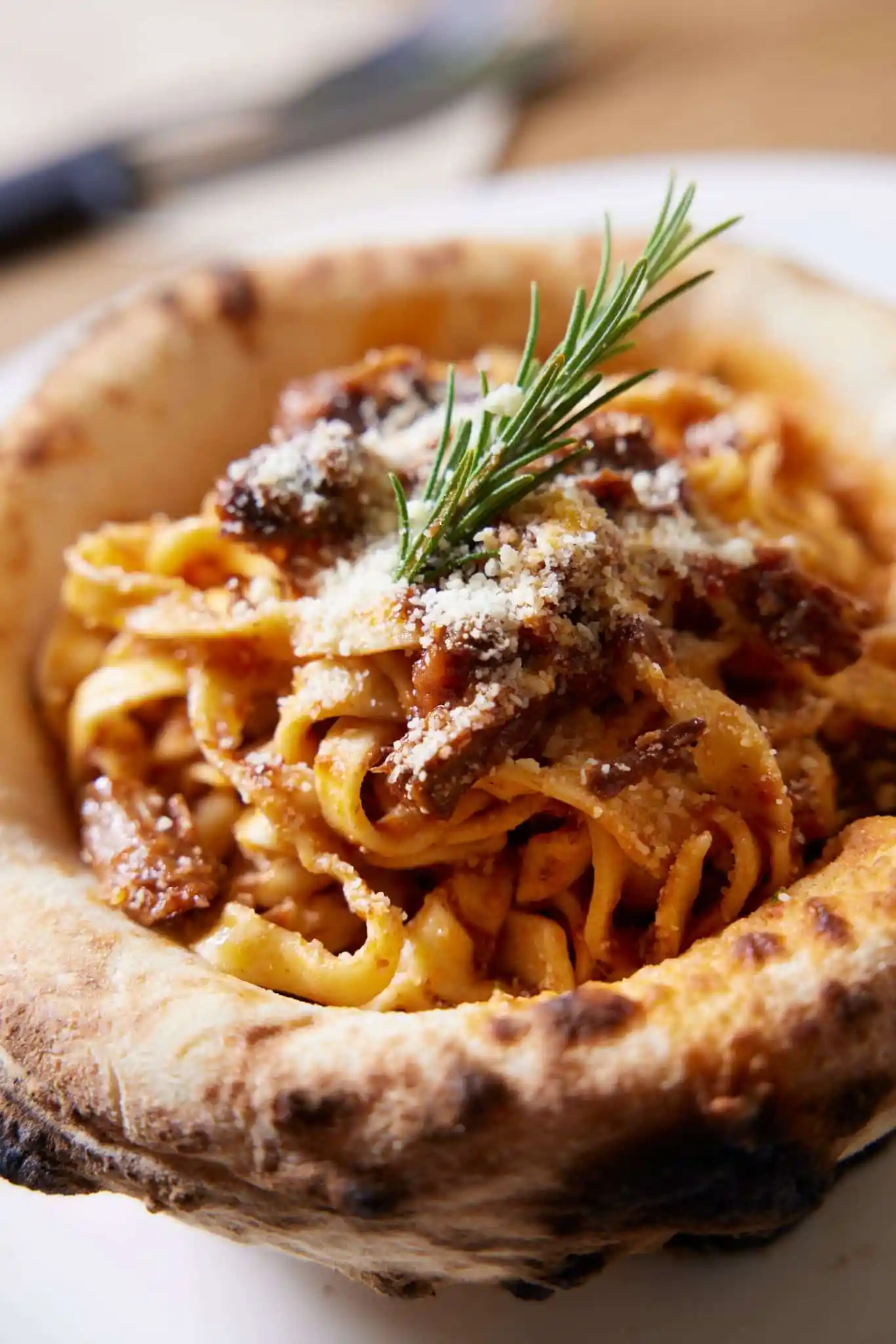 tagliatella duck pasta in a pizza bowl