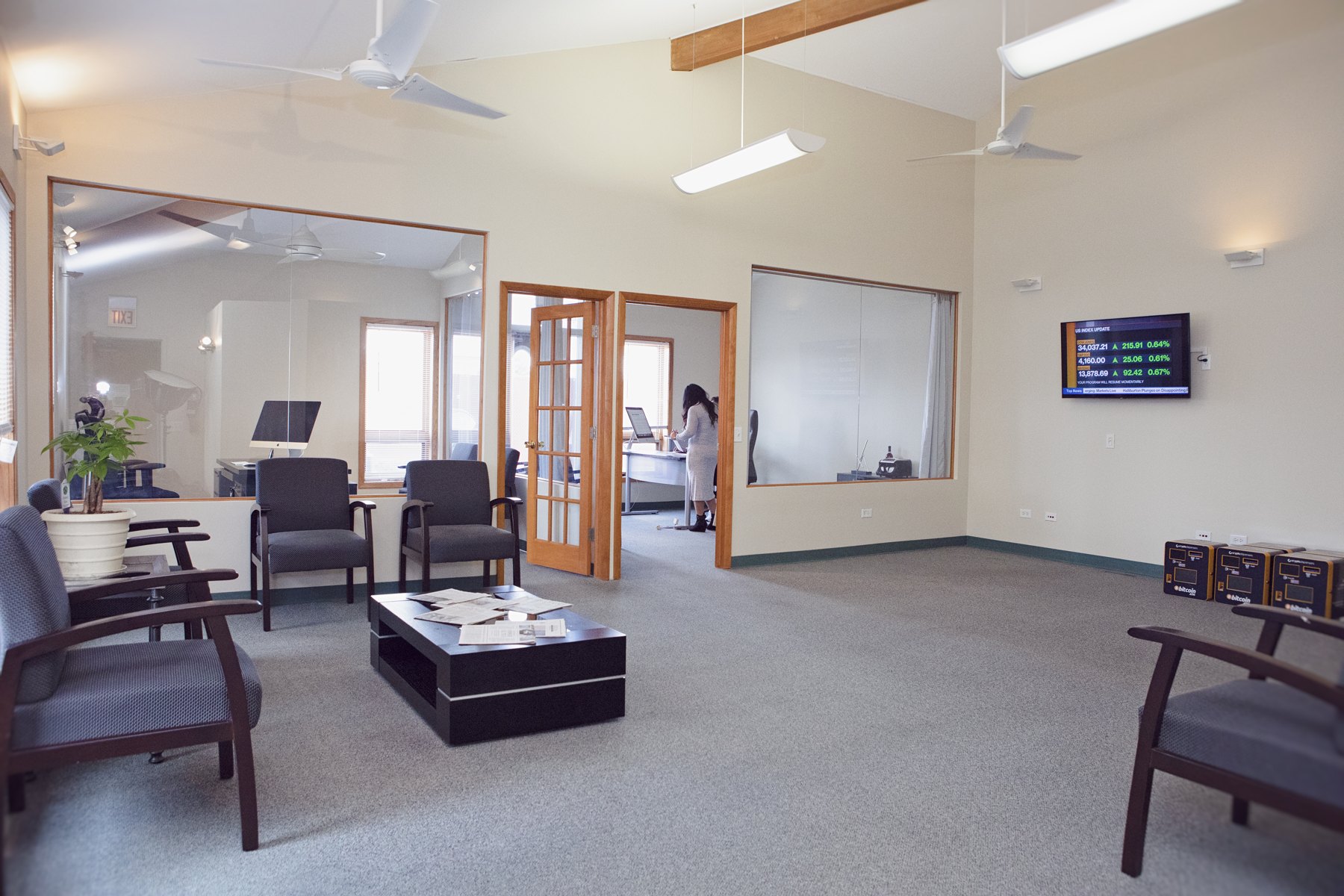 A wide view of the Crypto Dispensers office with desks, seating, and a conference area.
