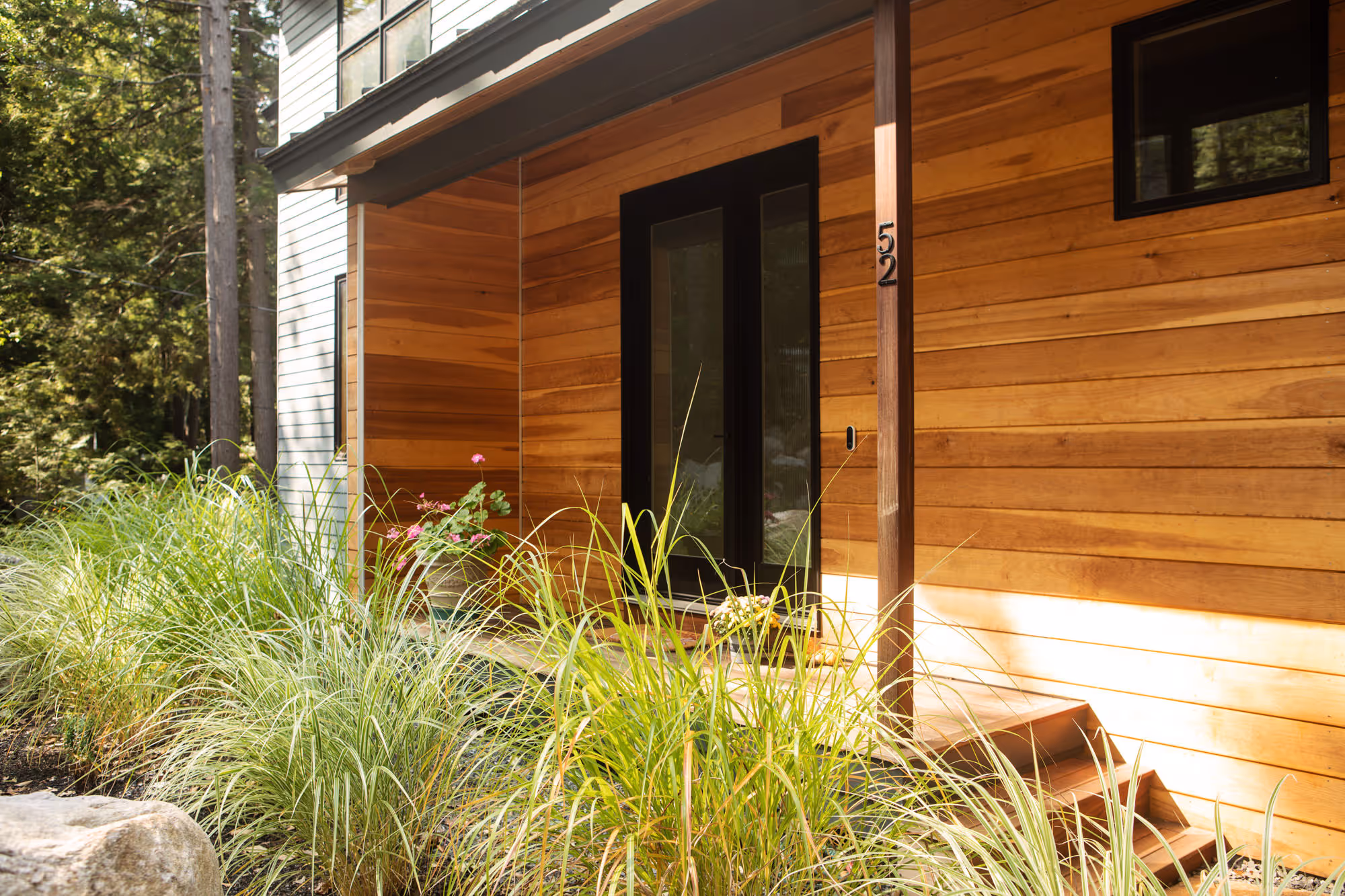 Wittemore Cove exterior with detail of grassy landscape and side entrance