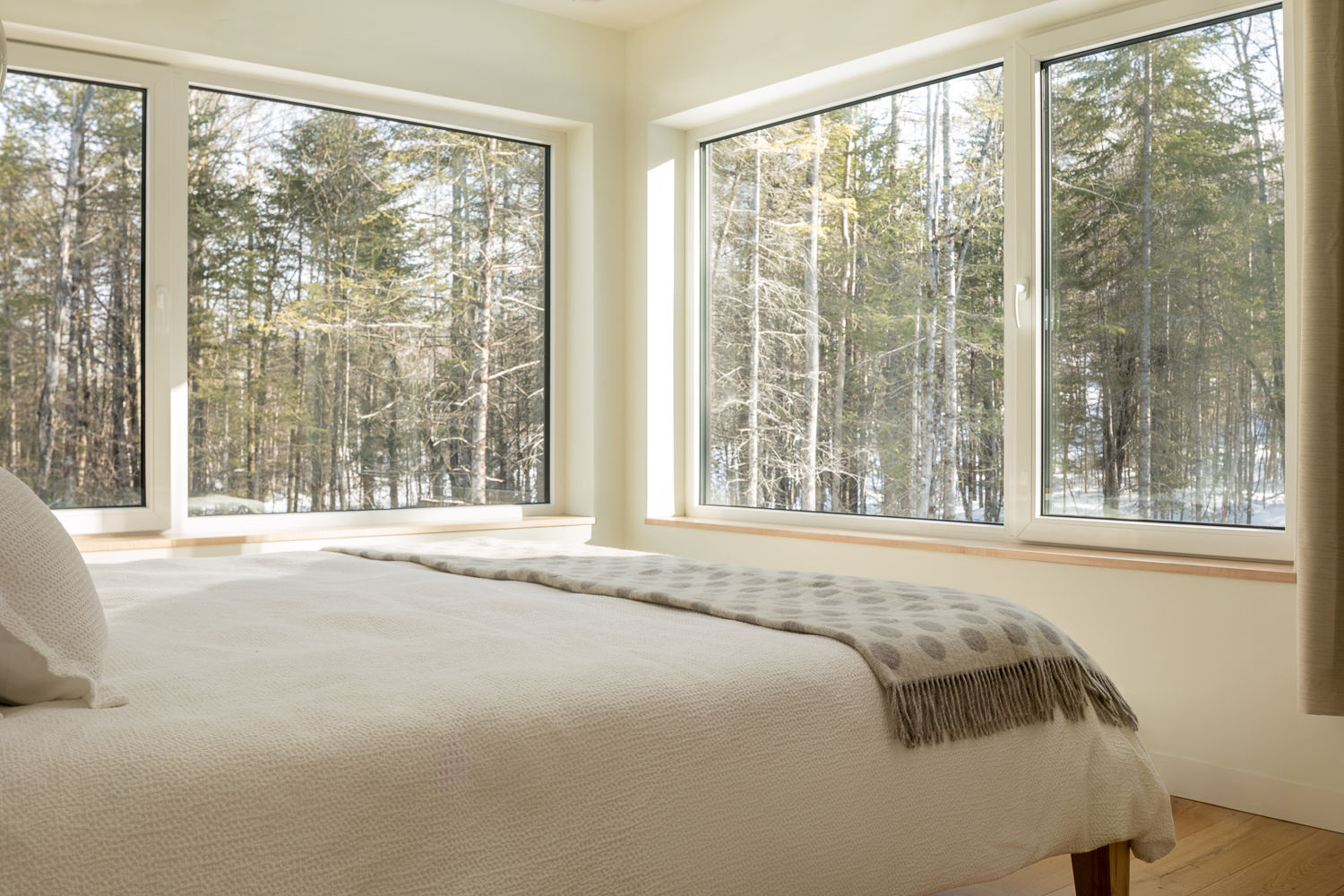 Kevin Browne architecture: Maine home bedroom with expansive forest views
