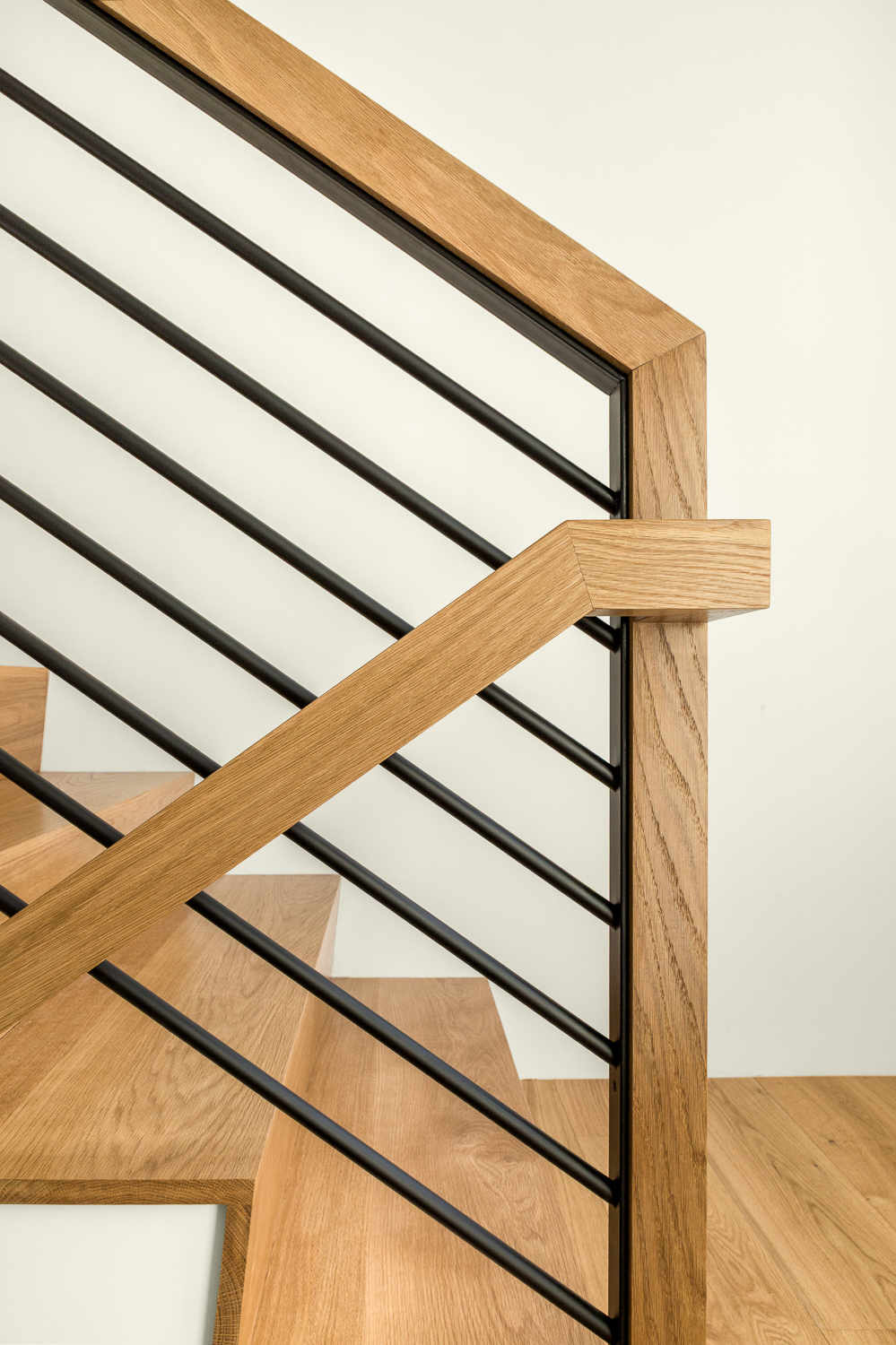 Kevin Browne's modern Maine home architecture with wooden stairs and sleek railing
