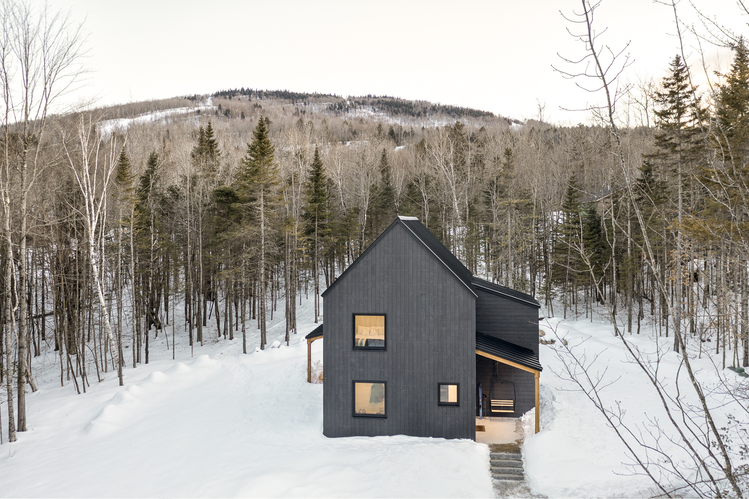 Kevin Browne's minimalist Maine home nestled in snowy forest landscape