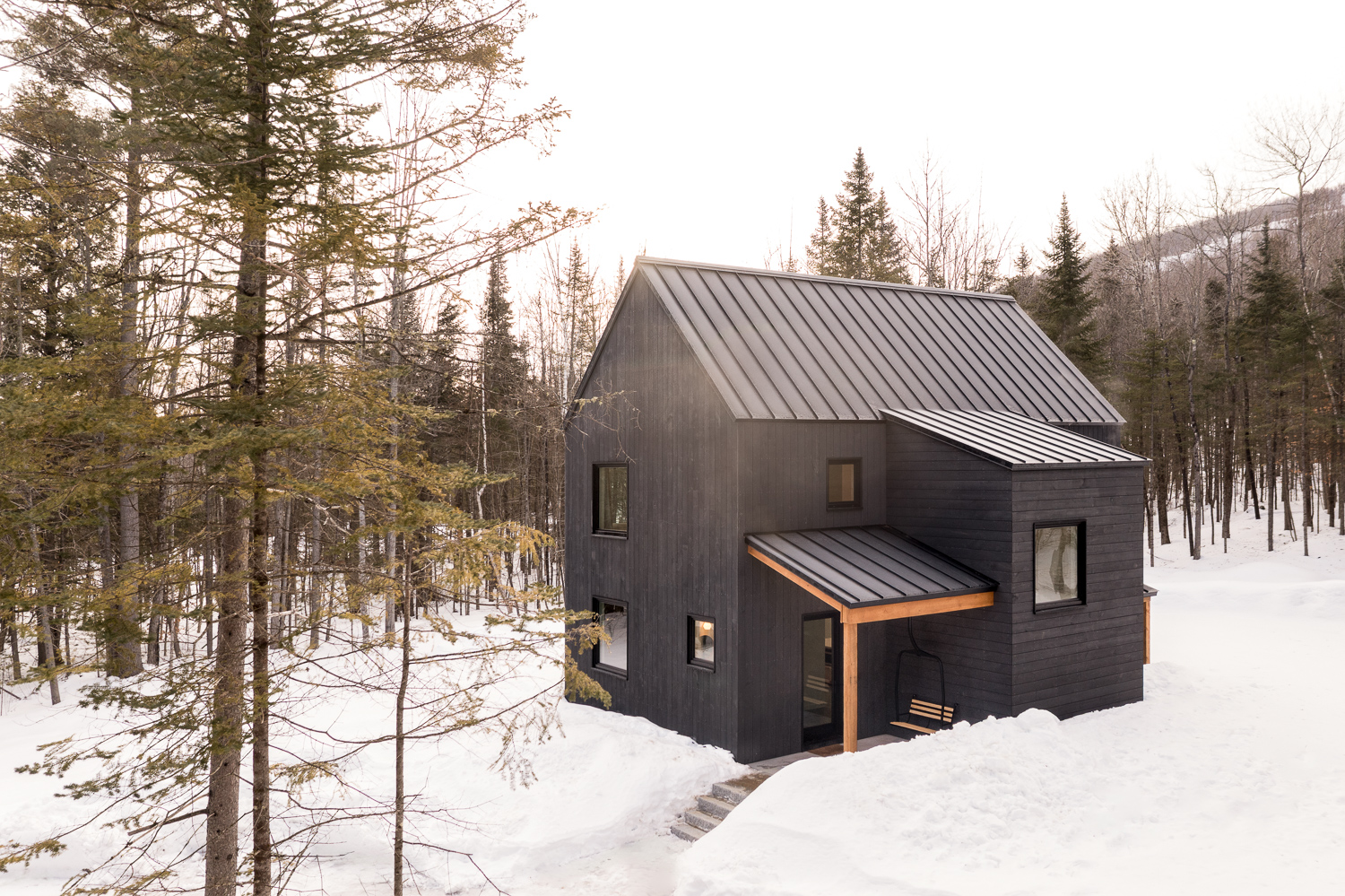 Kevin Browne's modern Maine home nestled in snowy forest architecture