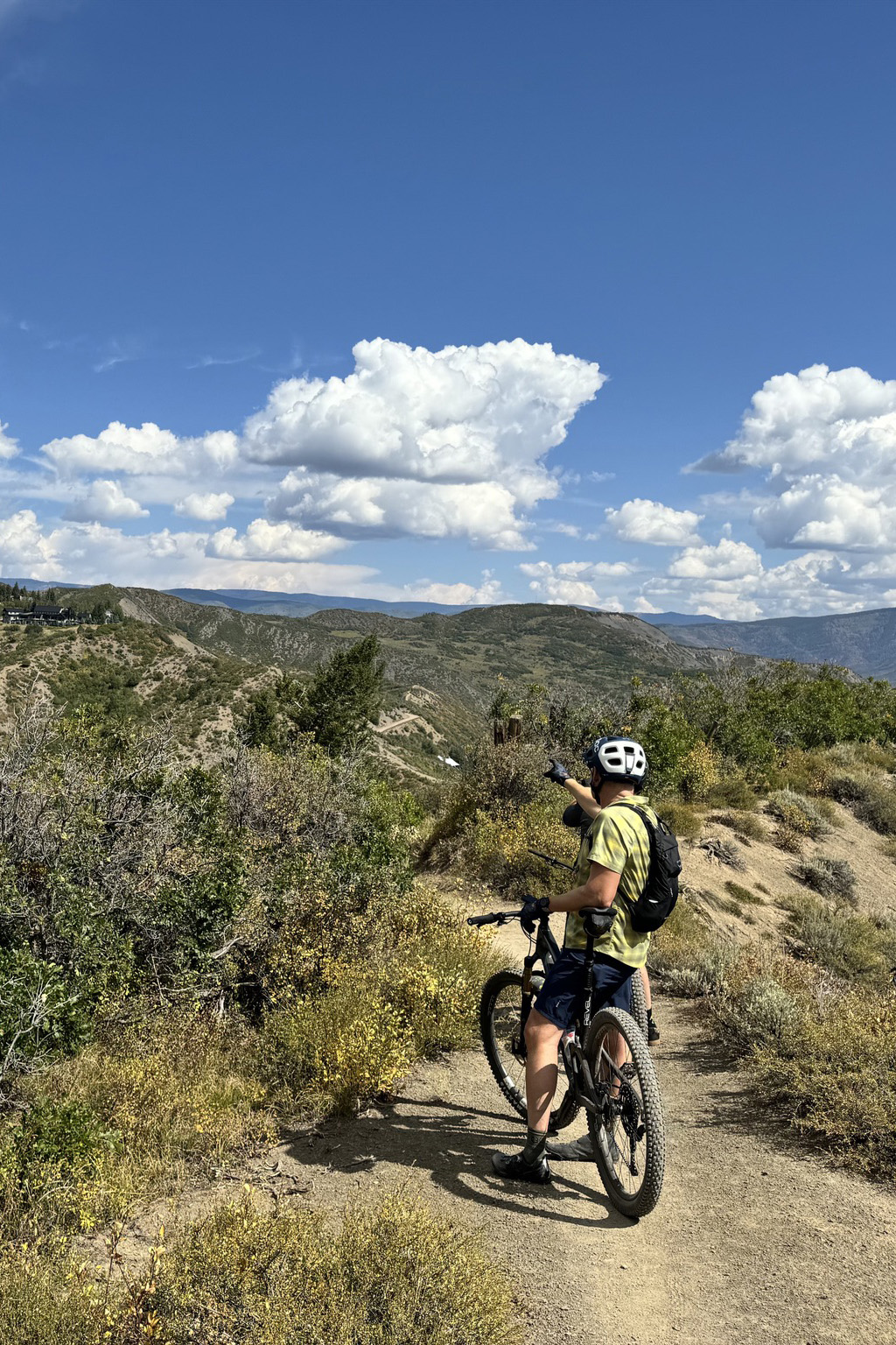 Bicyclist on off road path with blue skies