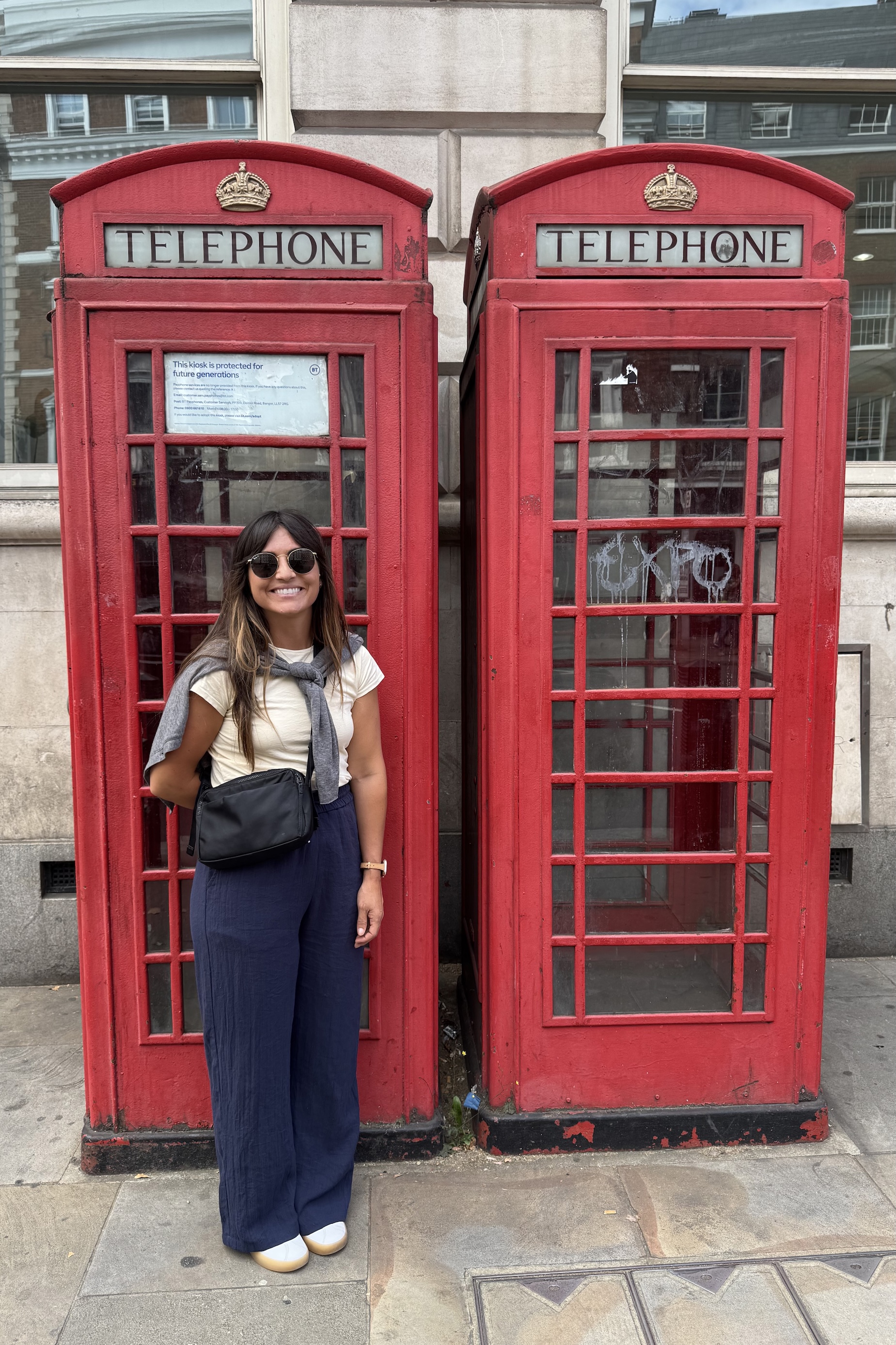 Person in front of red telephone booth